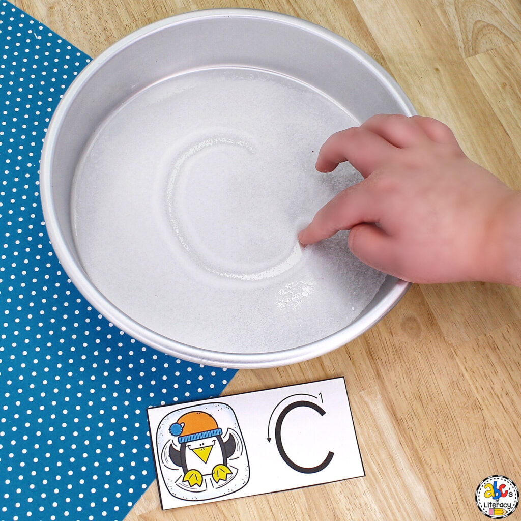 Snow Angel Alphabet Writing Tray: Practice writing strokes and capital & lowercase letter formation in this sensory activity Sensory Activity